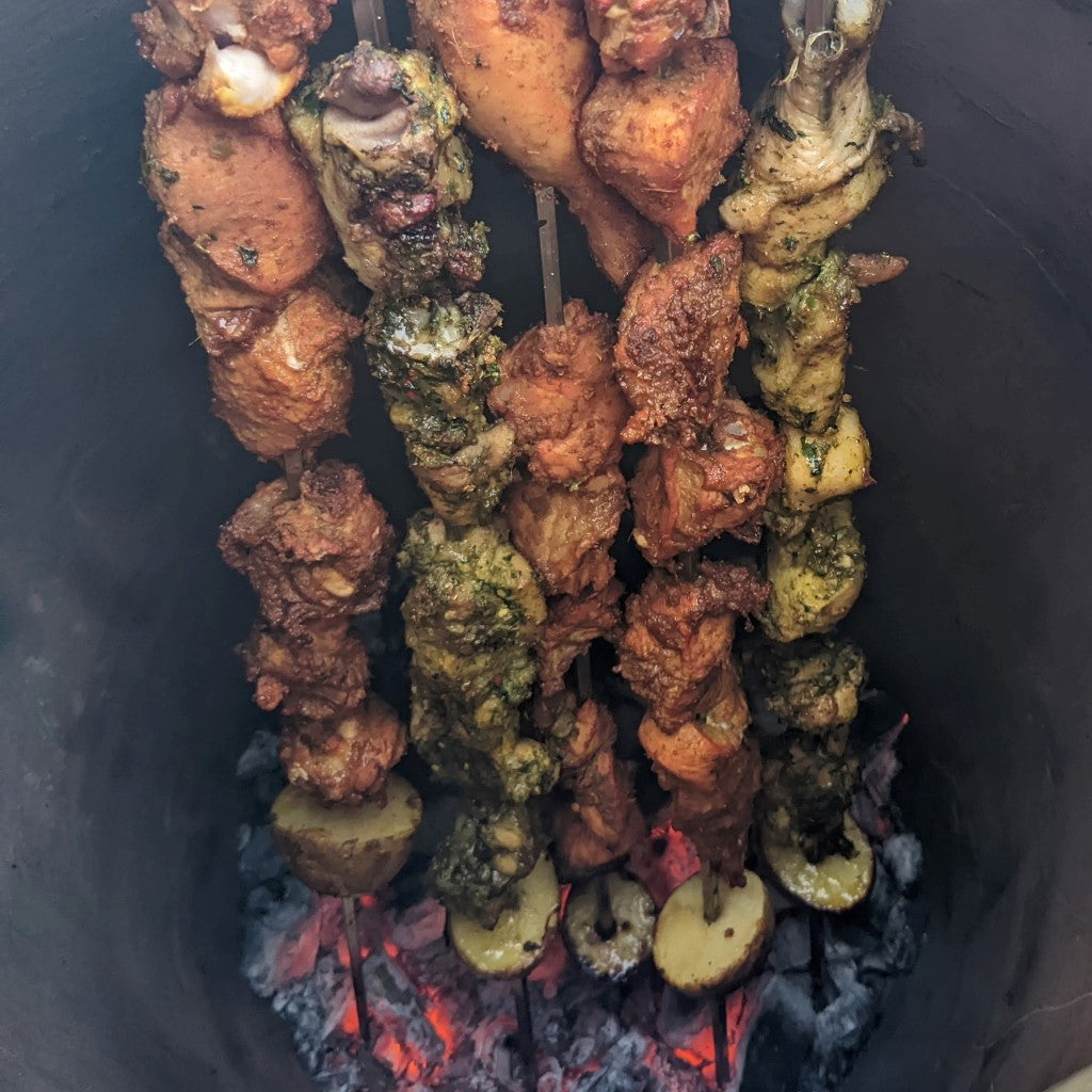 green chicken and chicken wings in large tandoor